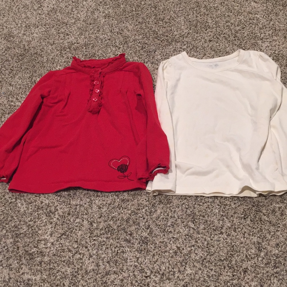Set of two shirts, one red and one cream.